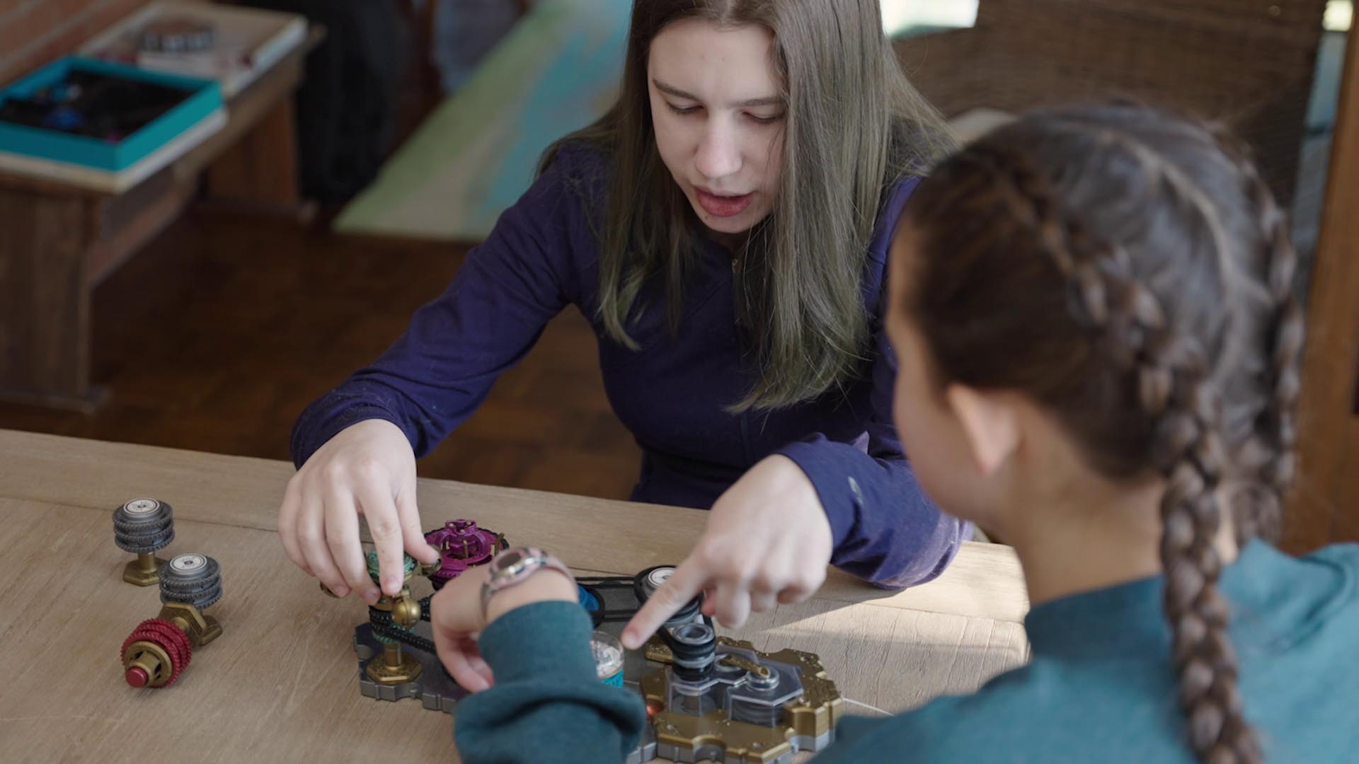 girls playing Spintronics at a table